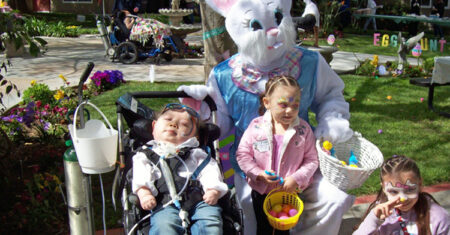 Children posing for a photo with the Easter Bunny